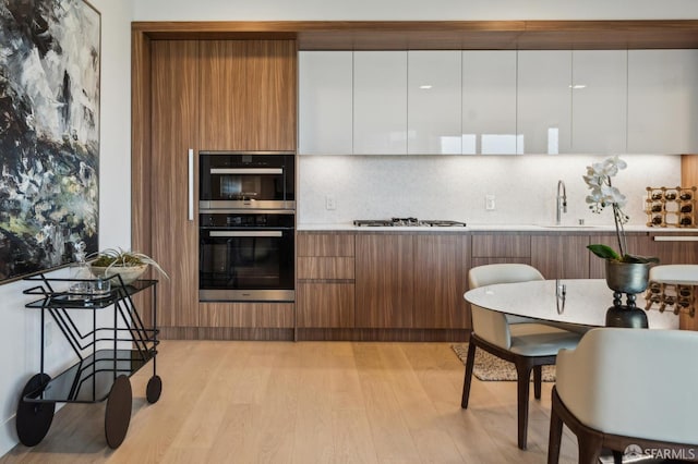 2177 3rd St Unit 421, San Francisco, CA 94107 - kitchen with modern cabinets, a sink, and light wood-style flooring