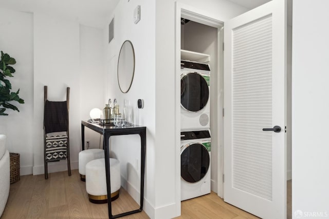 2177 3rd St Unit 421, San Francisco, CA 94107 - laundry area with stacked washer and clothes dryer, light wood-type flooring, and baseboards