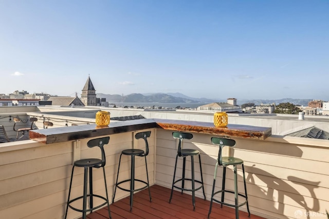 balcony featuring a mountain view and exterior bar