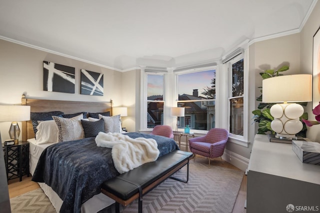 bedroom with wood finished floors and ornamental molding