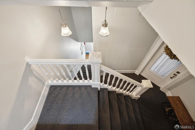 stairway featuring carpet and vaulted ceiling