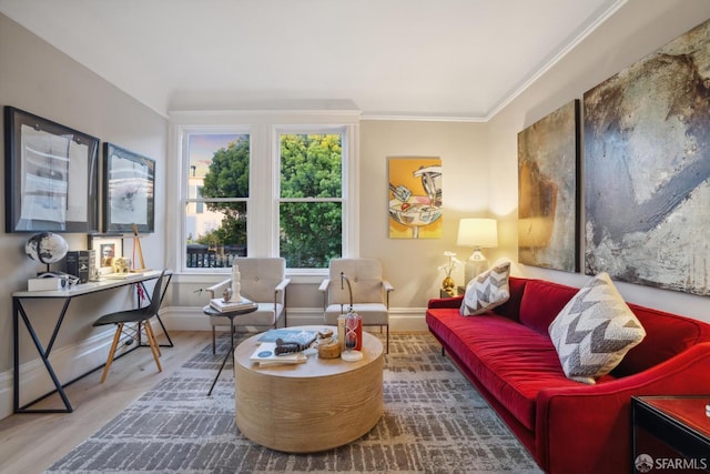 living room featuring wood finished floors, baseboards, and ornamental molding
