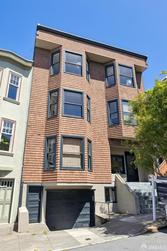 view of building exterior with an attached garage
