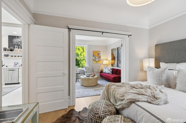 bedroom featuring wood finished floors and crown molding