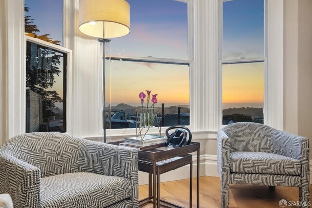 sitting room with wood finished floors and baseboards