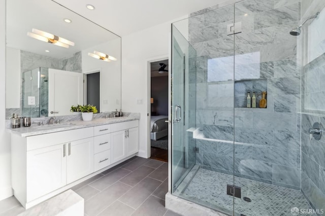 bathroom with vanity and a shower with shower door