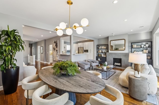 dining room with hardwood / wood-style flooring and a fireplace