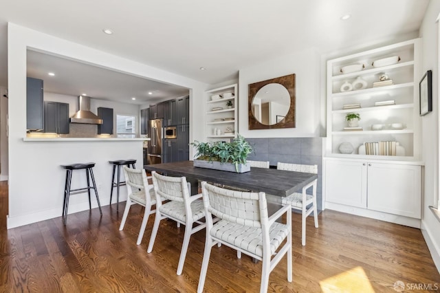 dining room with dark wood-type flooring and built in features