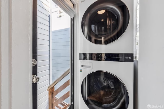 clothes washing area featuring stacked washer / drying machine