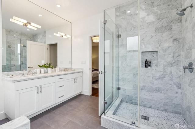 bathroom with tile patterned floors, vanity, and an enclosed shower