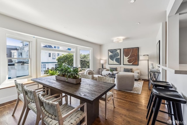 dining space with dark hardwood / wood-style flooring