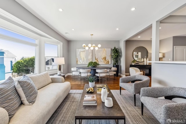 living room featuring dark wood-type flooring and a chandelier