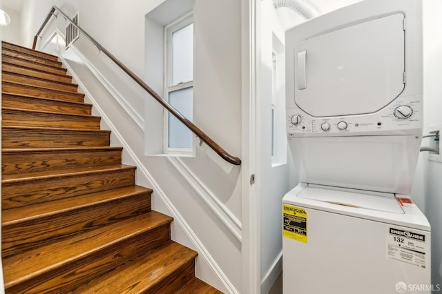 washroom featuring stacked washer / dryer