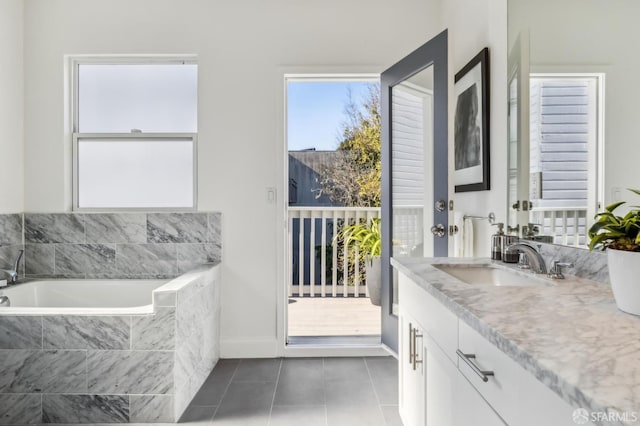 bathroom with vanity, tiled bath, and tile patterned floors