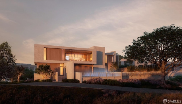 view of front of home featuring fence and stucco siding