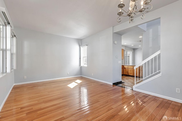 1027 Craftsman Dr, Hercules, CA 94547 - empty room featuring light wood-type flooring, baseboards, a chandelier, stairs, and recessed lighting