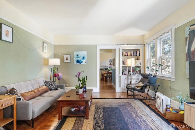 living room with baseboards and wood finished floors