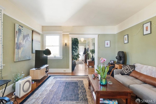 living room featuring wood finished floors and baseboards