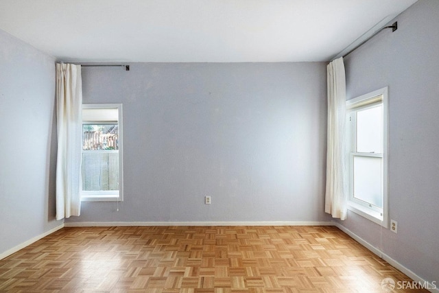 unfurnished room featuring baseboards