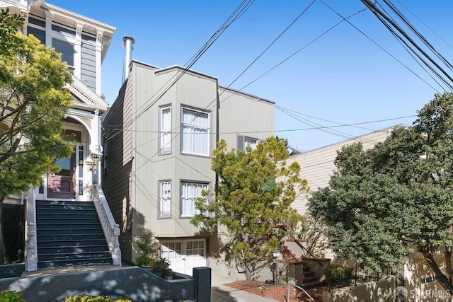 view of front of property featuring stairway