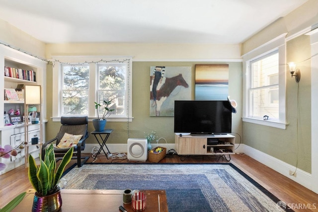 interior space featuring wood finished floors and baseboards