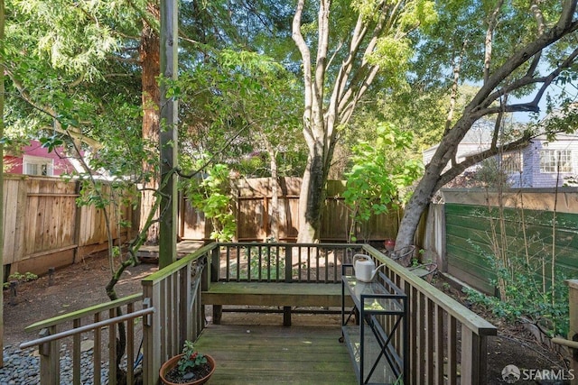 deck with a fenced backyard