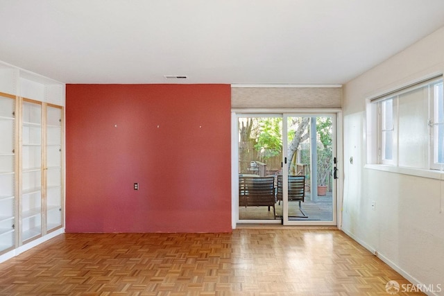 unfurnished room featuring visible vents