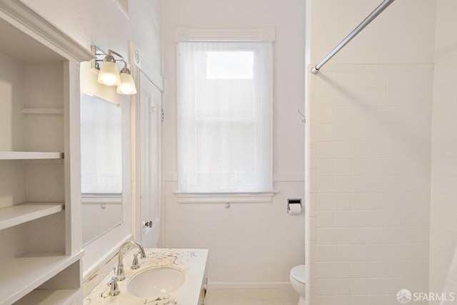 full bathroom featuring baseboards, vanity, and toilet