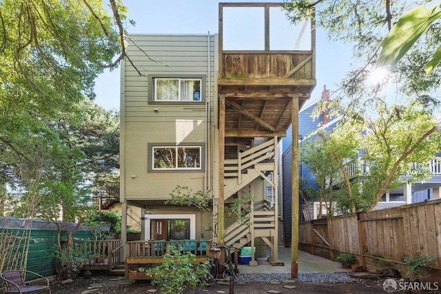 back of property featuring a fenced backyard and a wooden deck