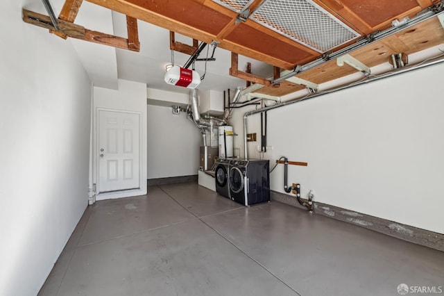 garage with a garage door opener and washer and dryer