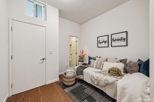 bedroom featuring connected bathroom and hardwood / wood-style floors