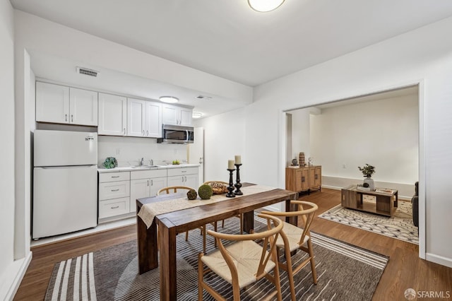 dining room featuring sink and dark hardwood / wood-style floors