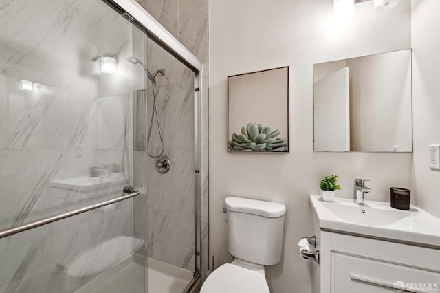 bathroom with vanity, toilet, and an enclosed shower