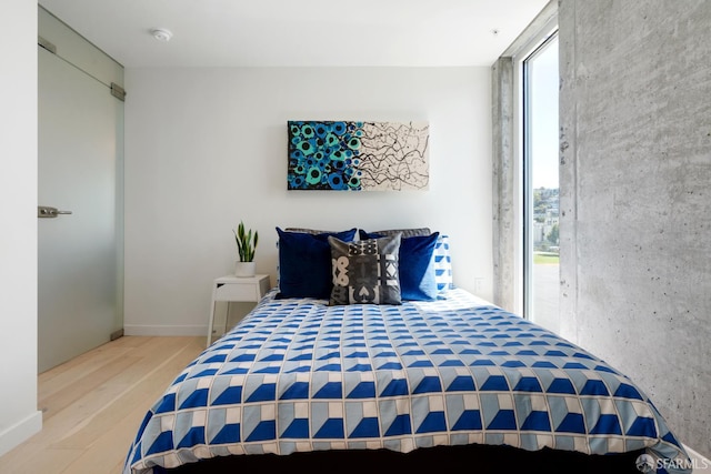 88 Arkansas St Unit 528, San Francisco, CA 94107 - bedroom featuring multiple windows, wood finished floors, and access to outside