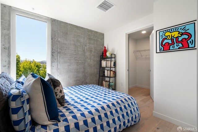 88 Arkansas St Unit 528, San Francisco, CA 94107 - bedroom with wood finished floors, baseboards, and a spacious closet