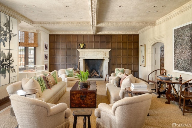 living room featuring ornamental molding, coffered ceiling, beamed ceiling, a fireplace, and wood walls