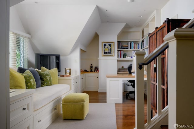 bedroom with light wood-type flooring and lofted ceiling