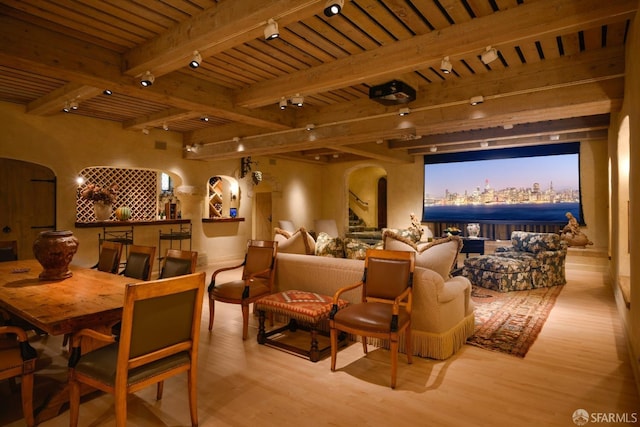 home theater room with beamed ceiling, light hardwood / wood-style flooring, and wood ceiling