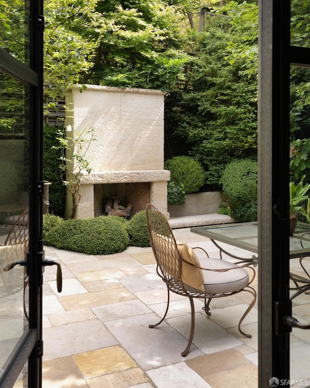 view of patio featuring an outdoor stone fireplace