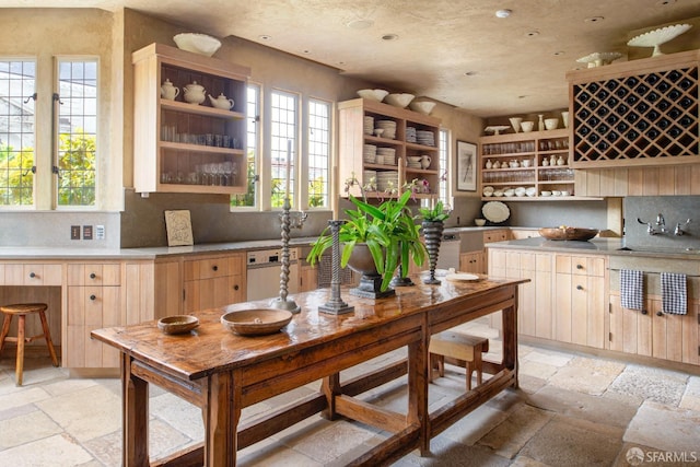 kitchen with light brown cabinetry, sink, and plenty of natural light