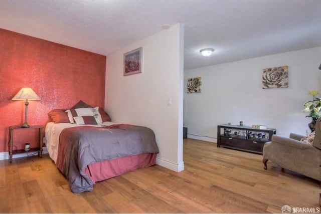 bedroom with light wood-type flooring