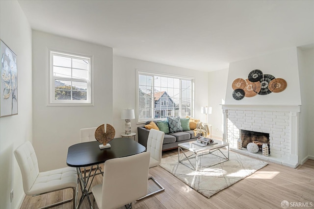 living room with a fireplace and light hardwood / wood-style floors