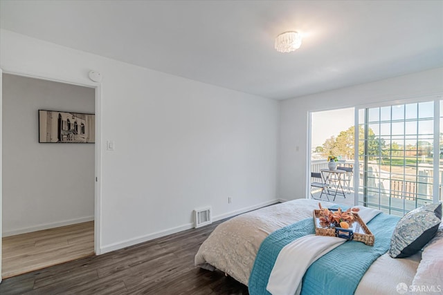 bedroom featuring access to outside and dark wood-type flooring