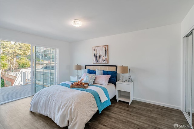 bedroom with access to exterior and dark wood-type flooring