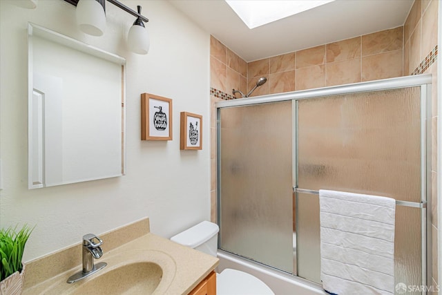 full bathroom featuring vanity, toilet, and combined bath / shower with glass door