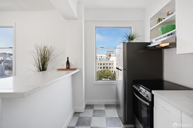 kitchen featuring range hood, a wealth of natural light, white cabinetry, and stainless steel electric range