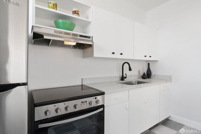 kitchen with white cabinets, light stone countertops, stainless steel appliances, sink, and extractor fan