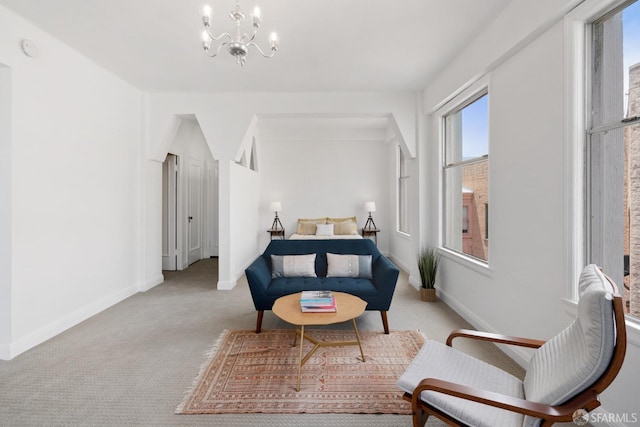 interior space featuring light colored carpet and an inviting chandelier