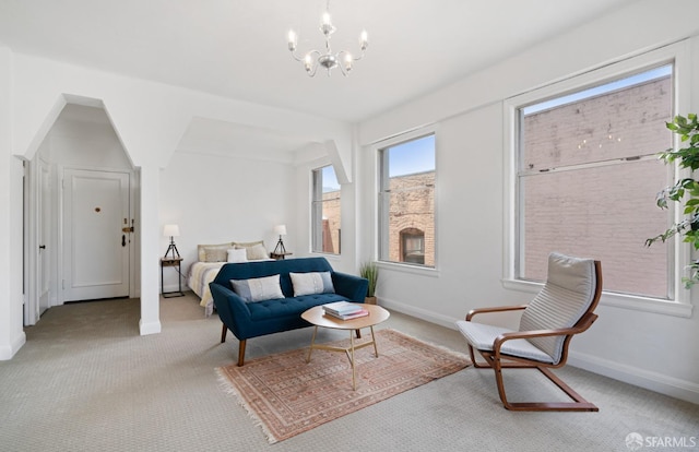 sitting room with light carpet and a notable chandelier