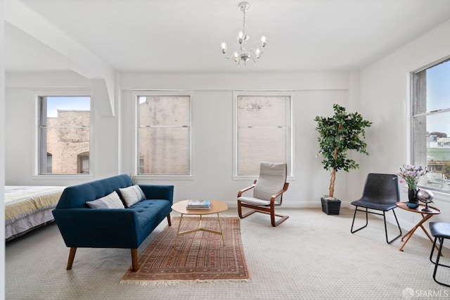 sitting room with carpet flooring and an inviting chandelier